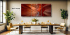 a modern dining room with a large, vibrant red abstract painting hanging on the wall above a wooden dining table set with wine glasses, plates, and a vase of flowers.