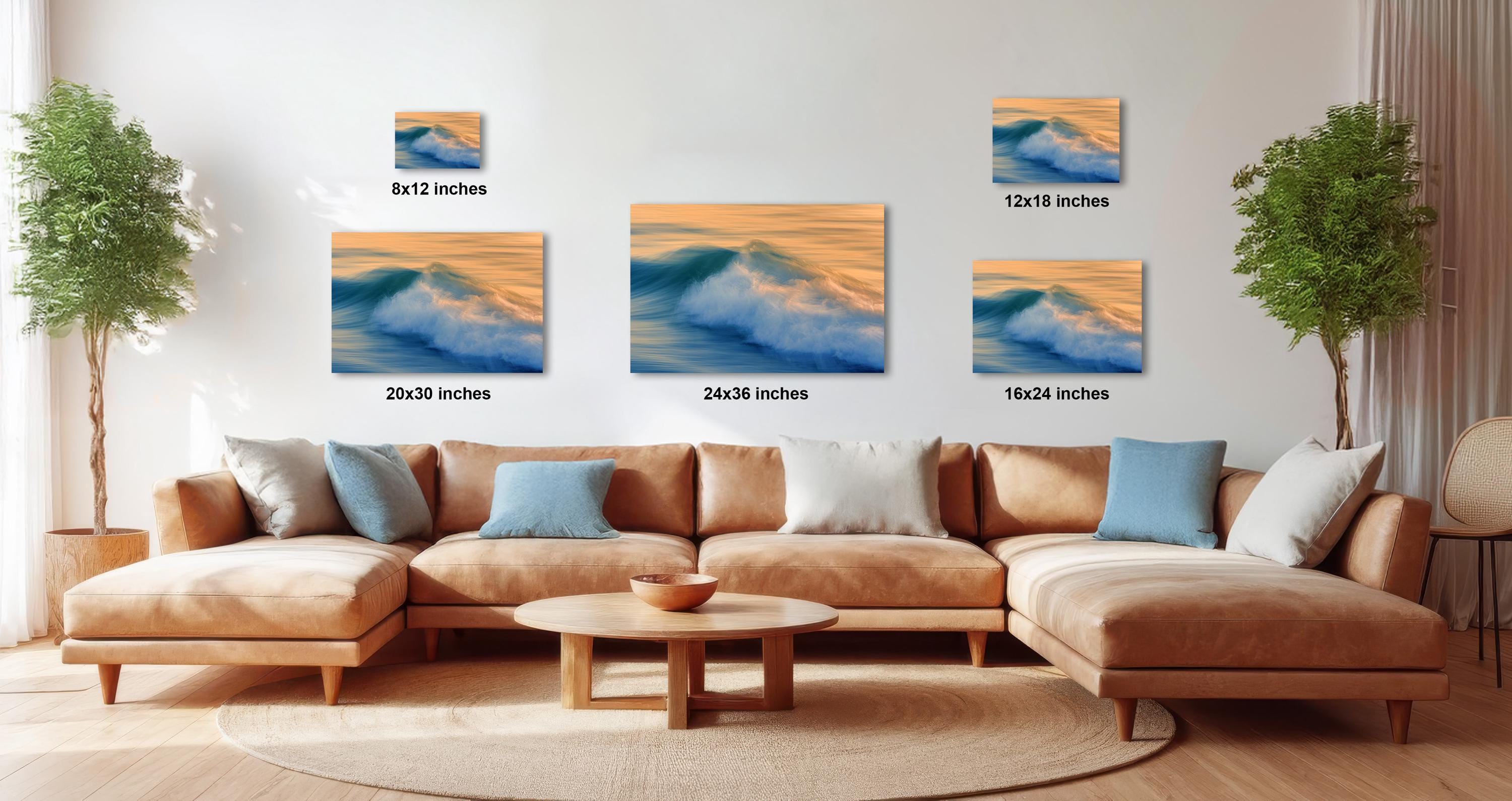 a modern living room with a large sectional sofa, a coffee table, and several potted plants. The walls are decorated with three framed photographs of ocean waves, each with a different size and resolution. The photographs are arranged in a grid-like pattern, with the largest one at the top and the smallest one at the bottom. The text "20x30 inches" is visible, indicating the size of each frame.