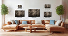 a modern living room with a large sectional sofa, a coffee table, and several potted plants. The sofa is positioned in front of a wall with three framed artworks displayed above it, each with a different size and resolution.