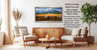 a living room with a wooden coffee table, two white armchairs, and a framed landscape photograph hanging on the wall.