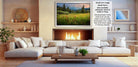 a cozy living room with a fireplace, white sofas, and a coffee table. The room has a warm and inviting atmosphere, with a fireplace providing a focal point and a painting of a field of flowers hanging above it.