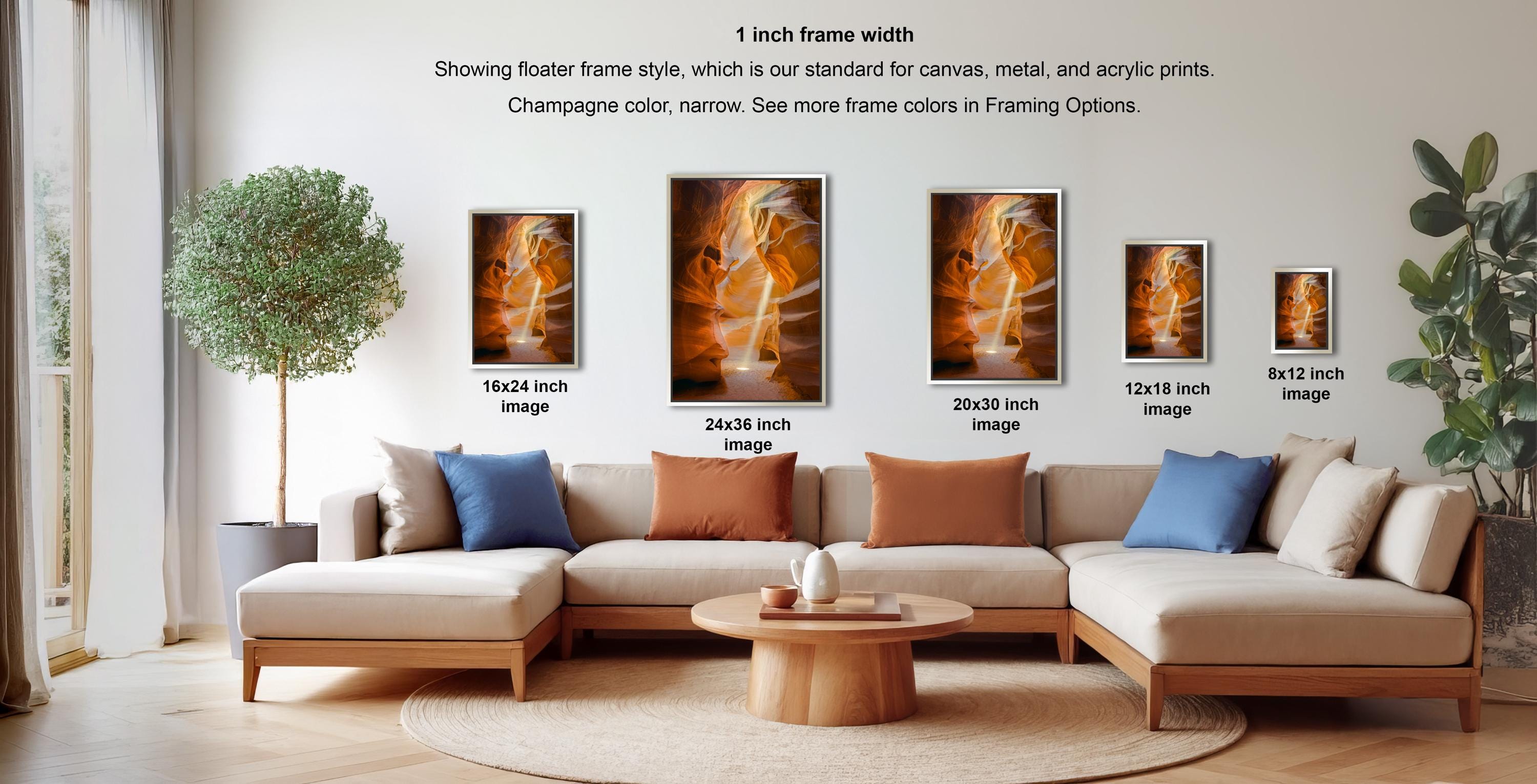 a living room with a large sectional sofa, a coffee table, and various framed artworks displayed on the wall.