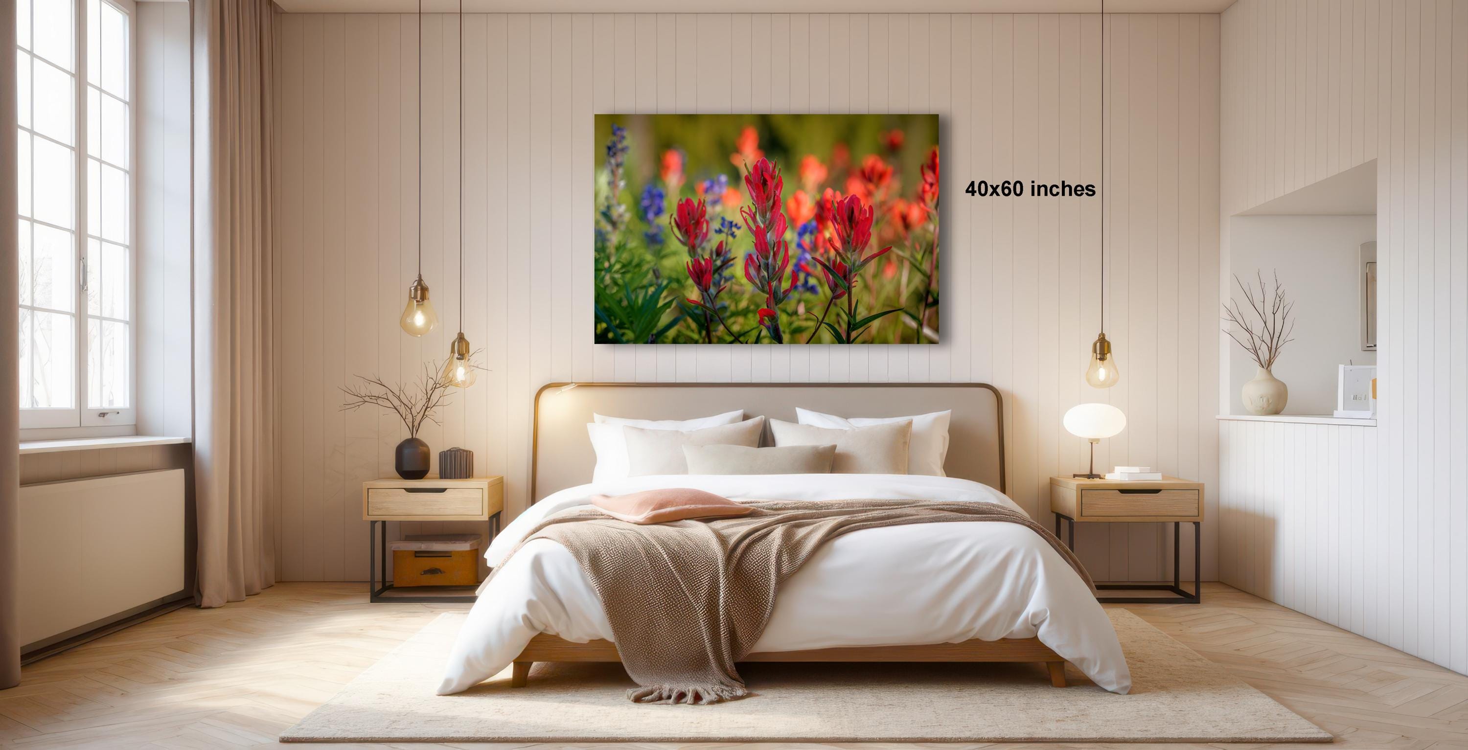 a serene bedroom with a large bed, wooden furniture, and a painting of flowers hanging on the wall.