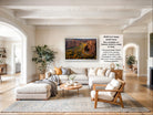 The image is a large framed picture of a canyon landscape hanging on a wall in a living room.
