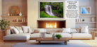 a cozy living room with a fireplace, white sofas, and a coffee table. The room has a warm and inviting atmosphere, with a fireplace providing a focal point and a painting of a waterfall adding an artistic touch.