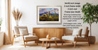 a cozy living room with a wooden coffee table, two beige armchairs, and a framed landscape photograph hanging on the wall.