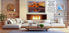 a cozy living room with a fireplace, white sofas, and a wooden coffee table. The room has a warm and inviting atmosphere, with a large framed picture of a desert landscape hanging on the wall.