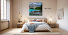 a serene bedroom with a large bed, wooden furniture, and a painting of a mountain lake with boats on the shore.