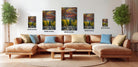 The image is a modern living room with a large sectional sofa, a coffee table, and several potted plants. The walls are decorated with framed landscape photographs of mountains and forests, and the furniture is arranged to create a comfortable and inviting atmosphere.
